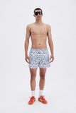 White Swim Shorts with 'Le Bel Été' print, a stylish collaboration by Edith Carron.